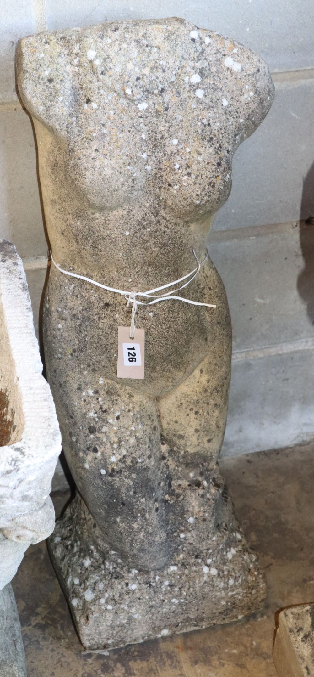 A reconstituted stone female torso garden ornament, H.84cm